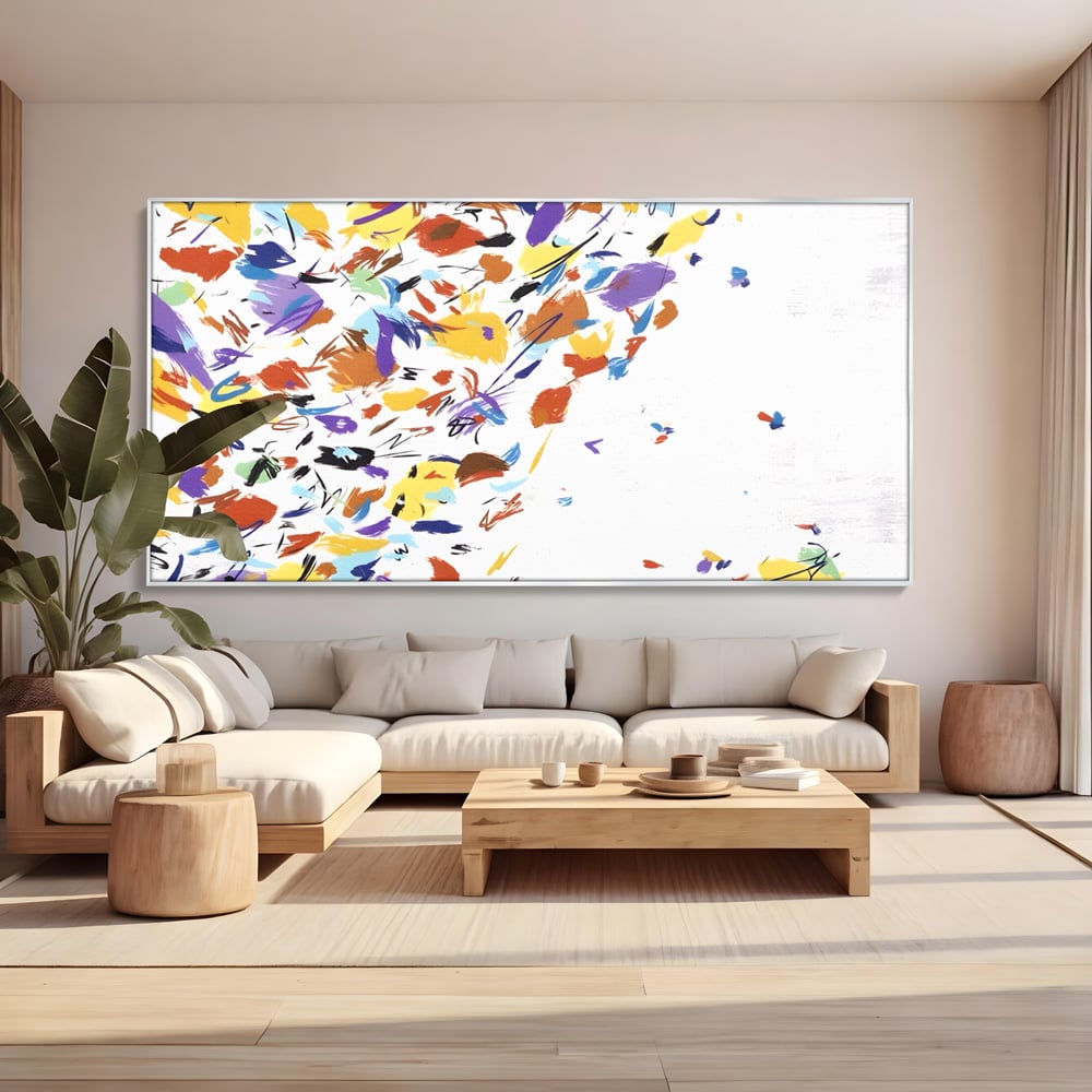 Tablou canvas cu pictura abstracta cu frunze colorate, in rama de aluminiu argintiu, pe perete intr-un living